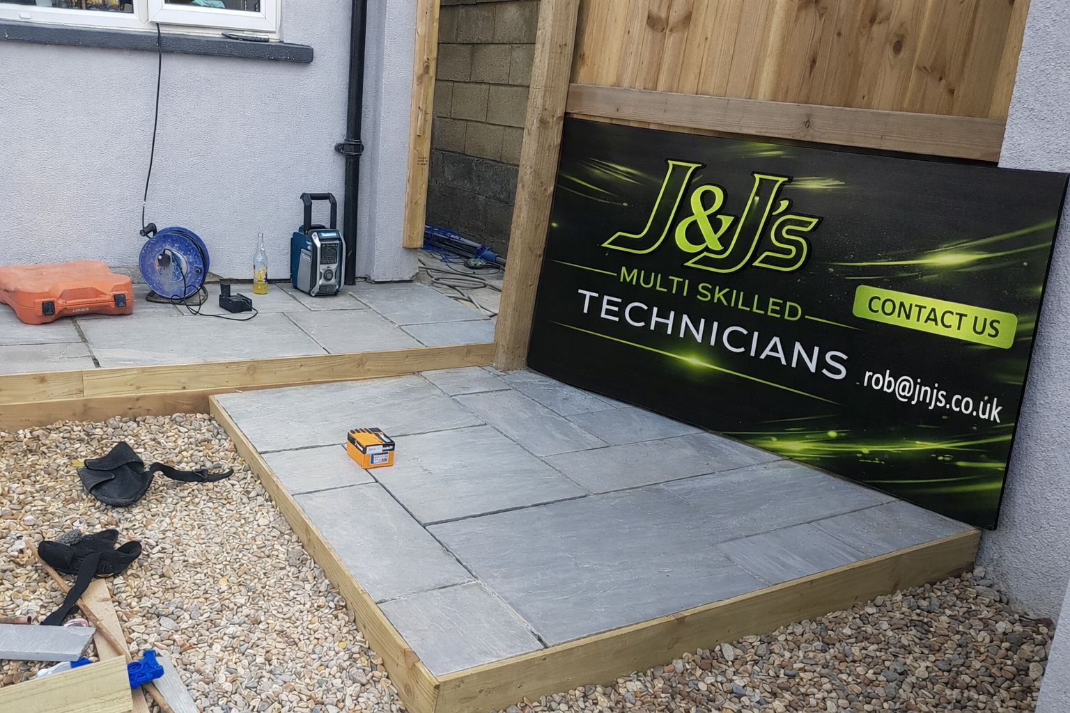 J&J's site board in front of exterior build work