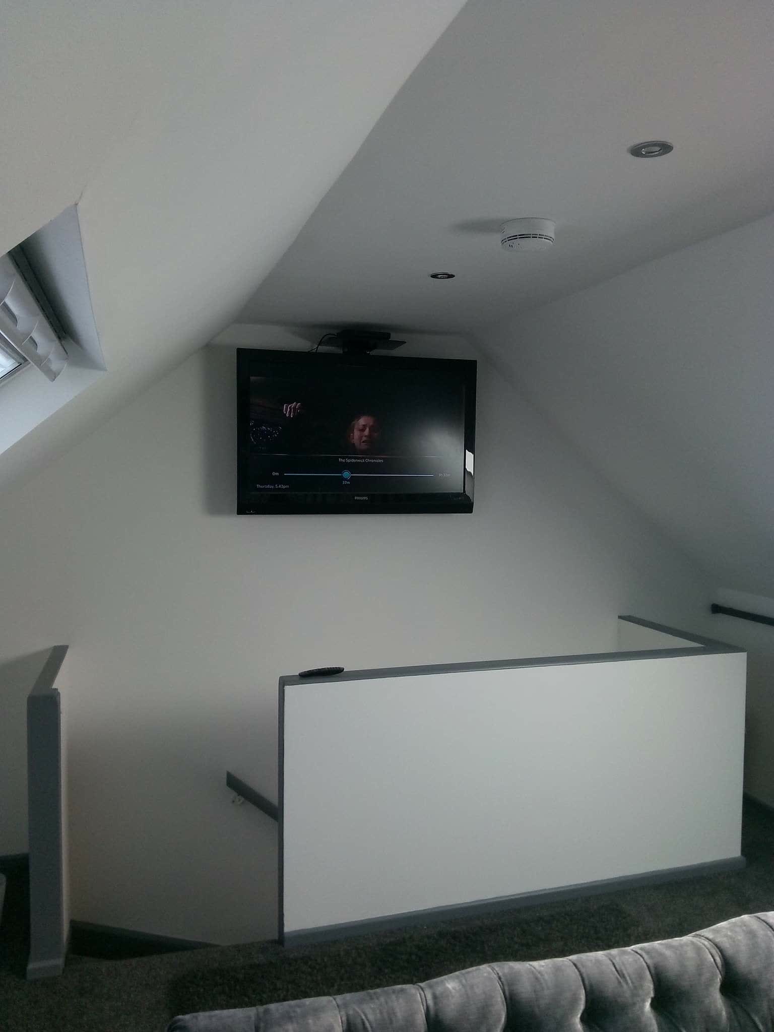 Finished attic room with wall-mounted television