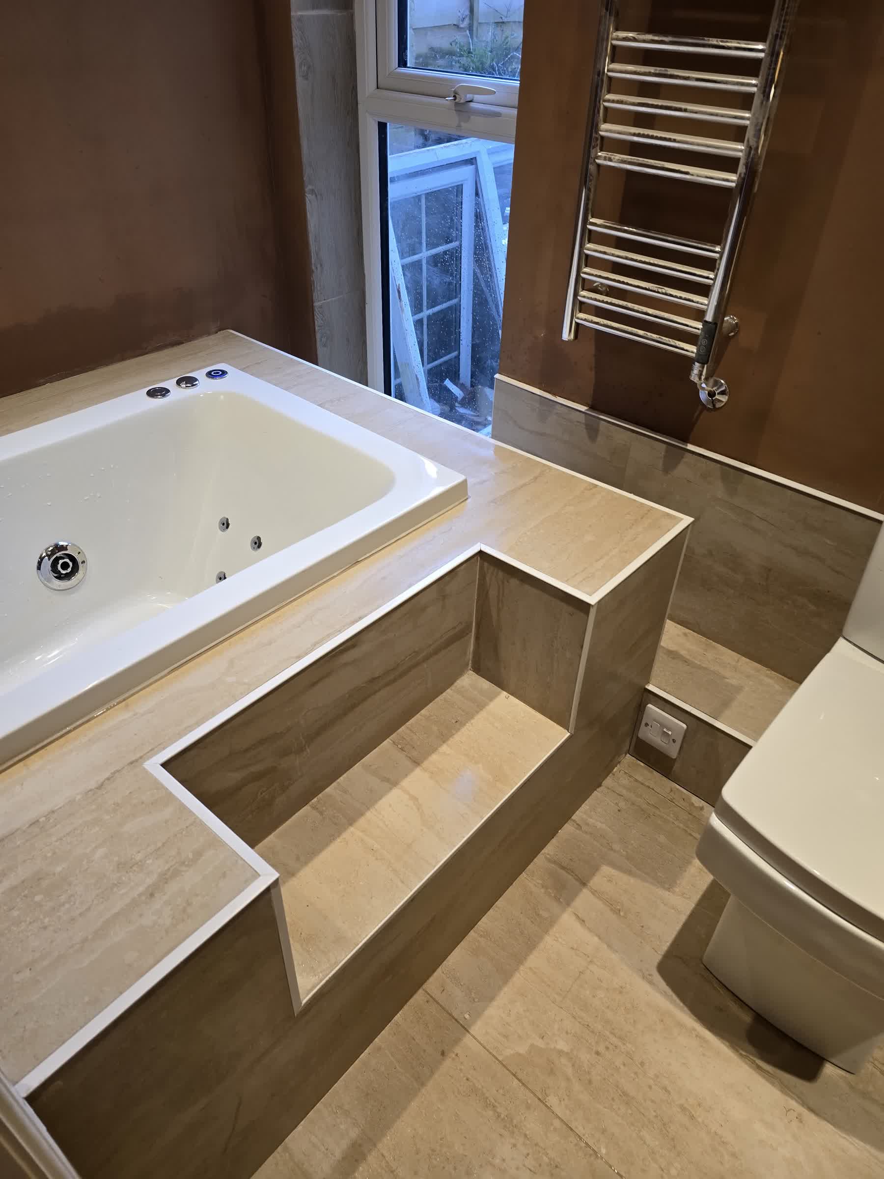 Finished tiled bathroom with a spa bath