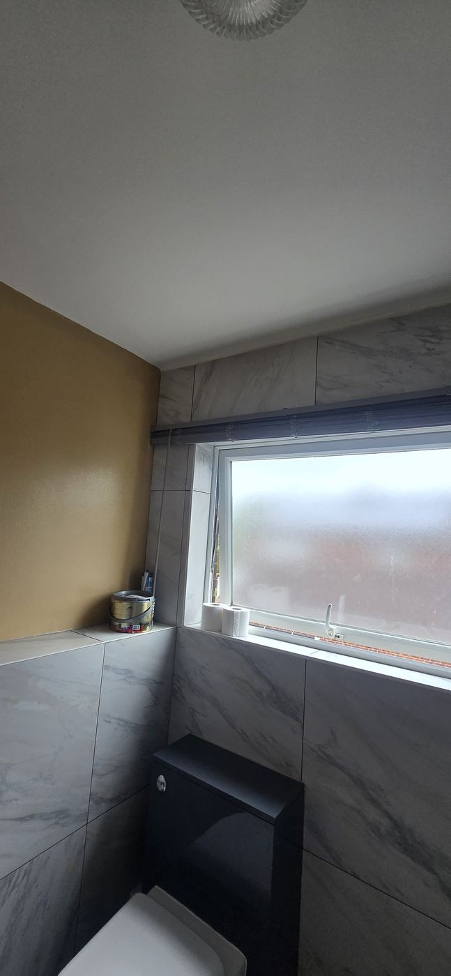 Bathroom finish with tiled walls and towel radiator