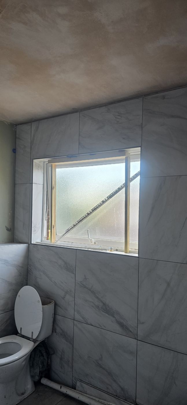 Bathroom tiling around a window